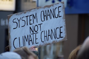 Sign that reads system change not climate change